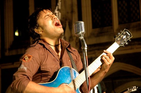 Najam playing blue guitar.JPG